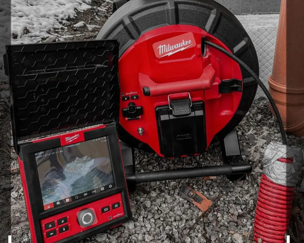 Close-up of Milwaukee sewer inspection camera equipment showing live footage of a pipe interior, used by D’Plumbers Inc. to locate blockages and diagnose underground plumbing issues.