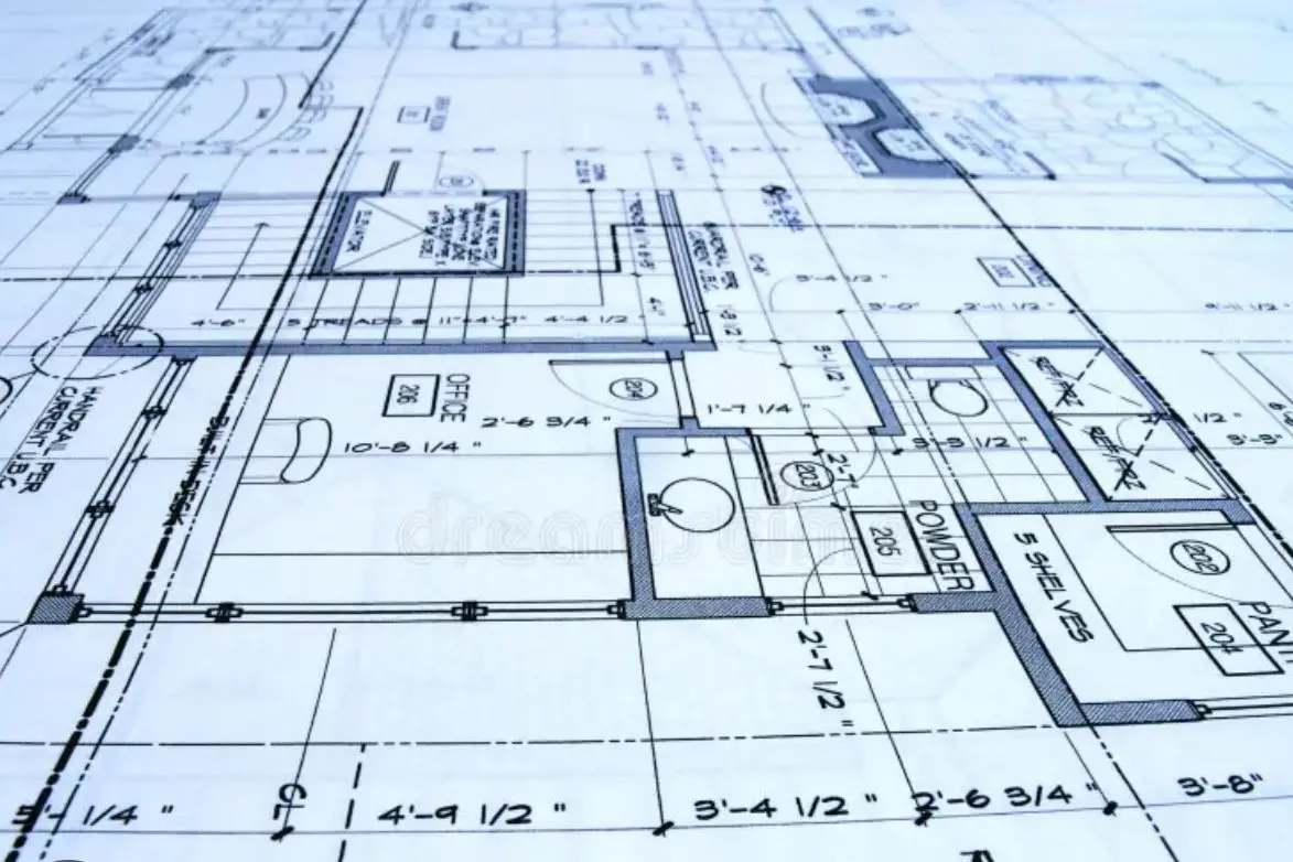 A close-up view of a detailed architectural blueprint featuring plumbing layouts, room dimensions, and fixture placements used in construction planning and take-off estimation.